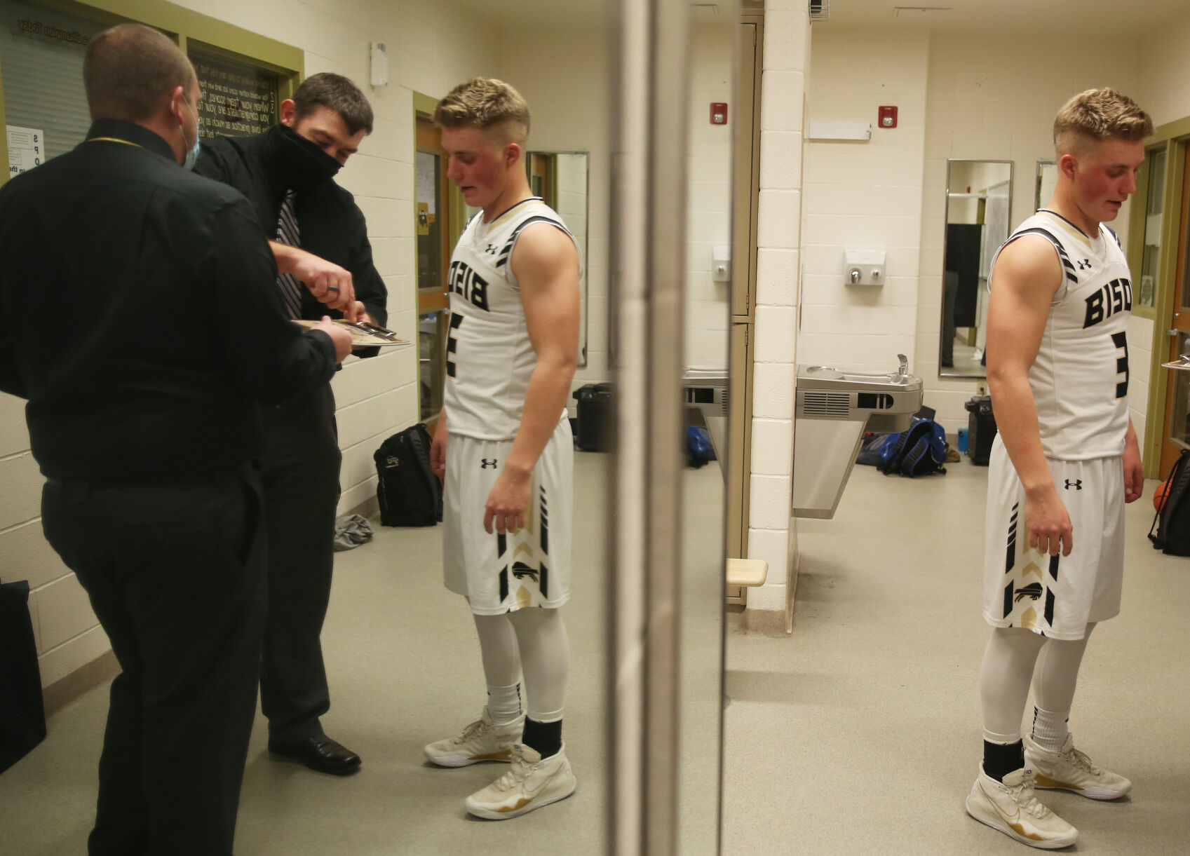 Hyrum Hatch goes over a play with assistant coach Ross Walker